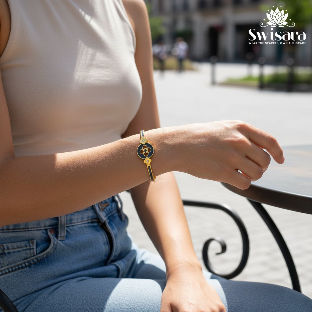 Onyx Emblem Bangle with gold-tone finish, black enamel centerpiece, clover motifs, and crystal accents – Swisara